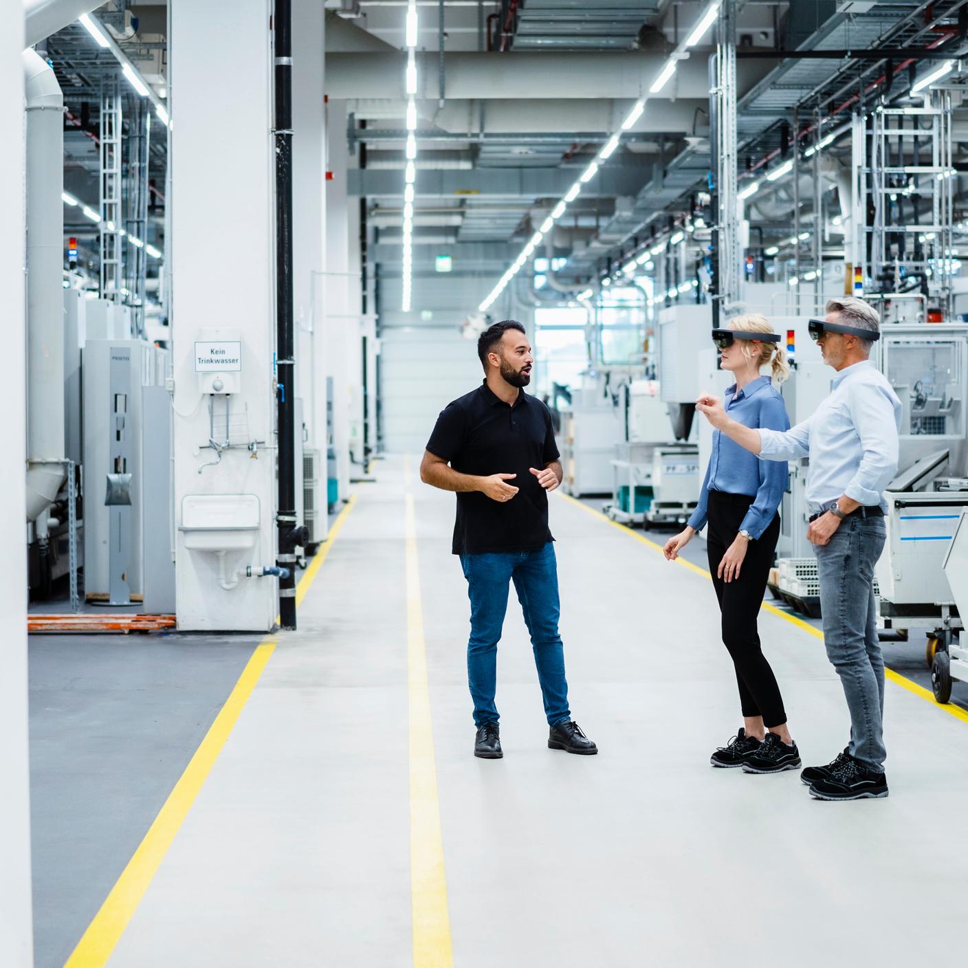 Engineer discussing with businessman and businesswoman