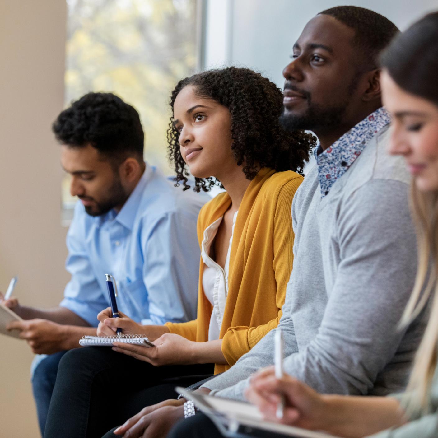 Business people sit in a row in a training class