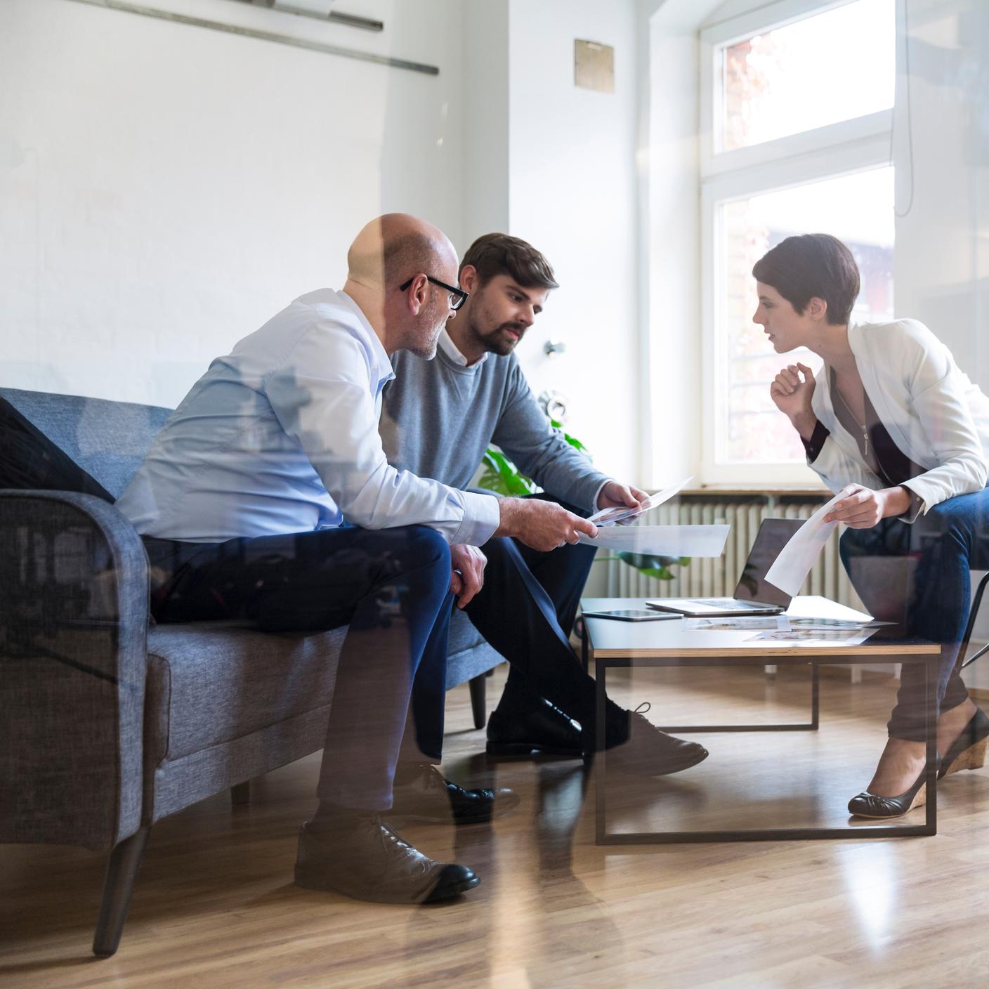 People around a small table reviewing plans