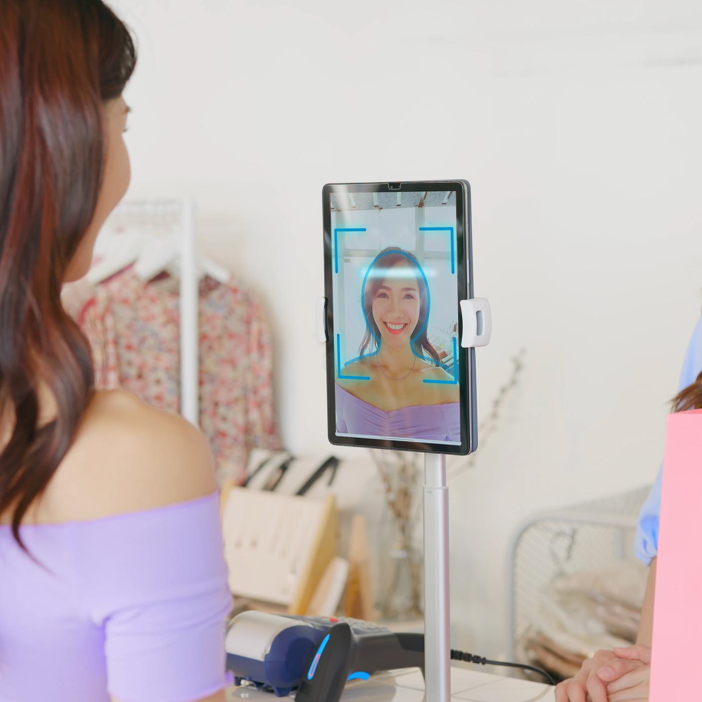 Girl using facial identification technology to make online credit card payment