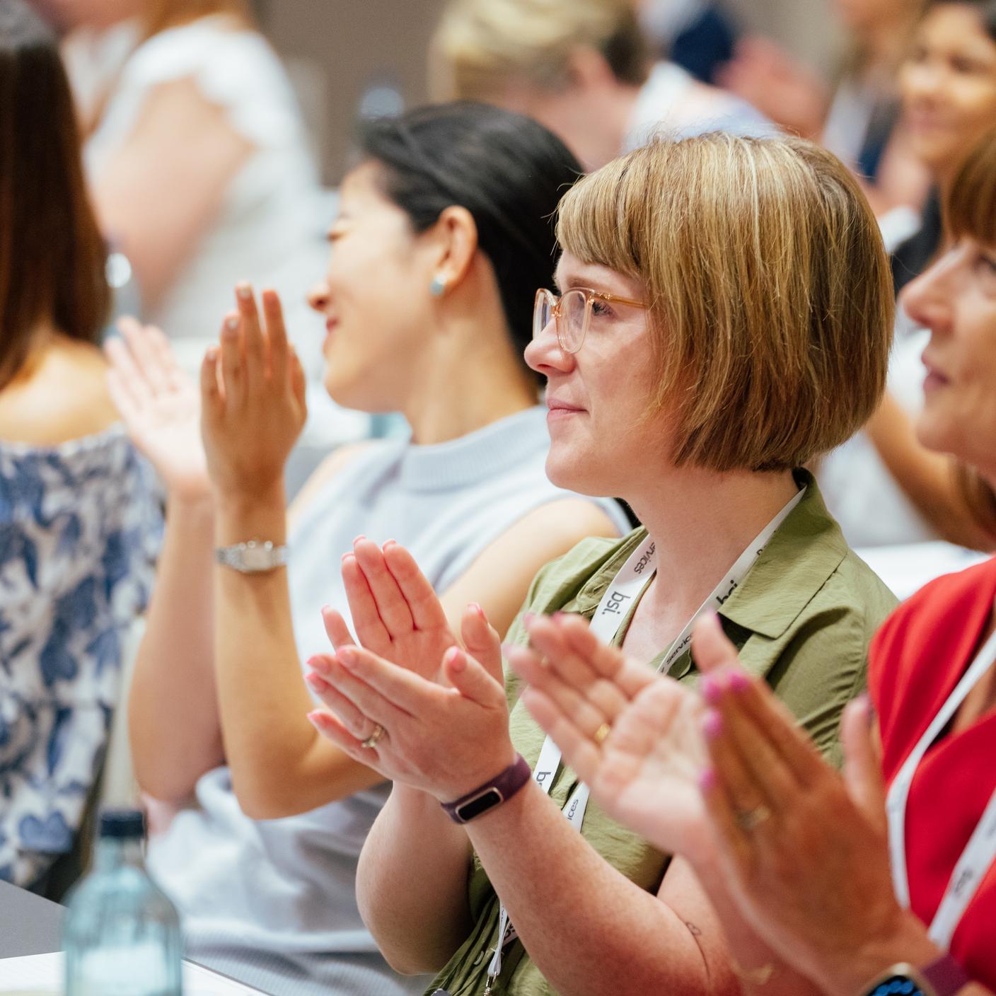 Consumer standards - females in audience clapping