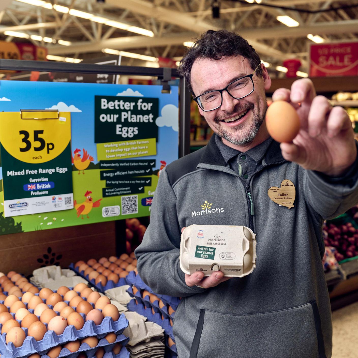 Morrisons worker holding an egg smiling