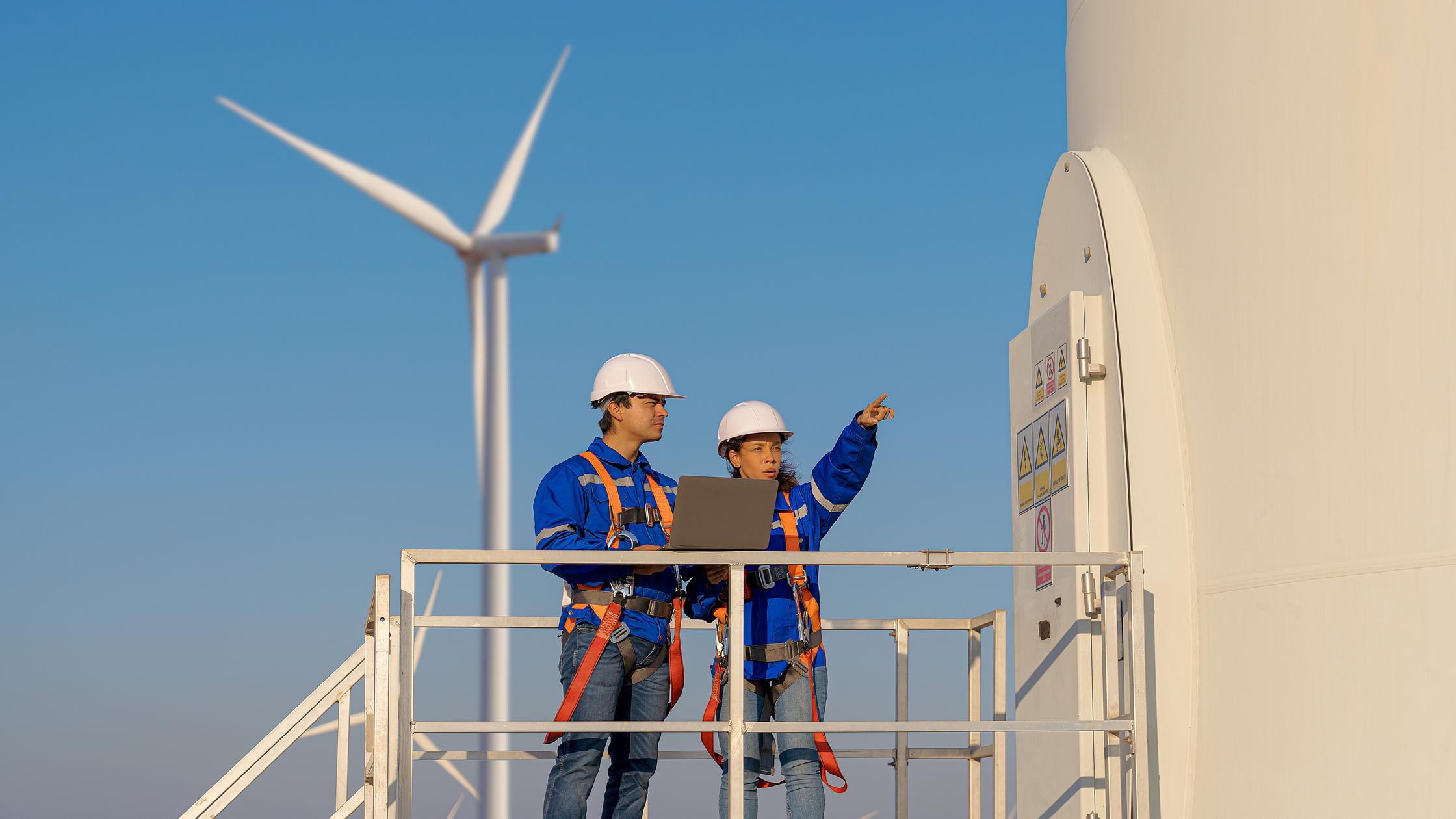 Quality - Maintenance engineers are checking wind turbines at wind power plant electric energy station