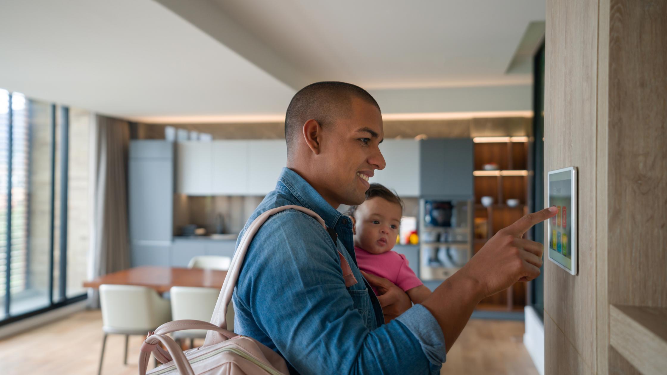 Artificial intelligence - father and toddler using wall electronic device